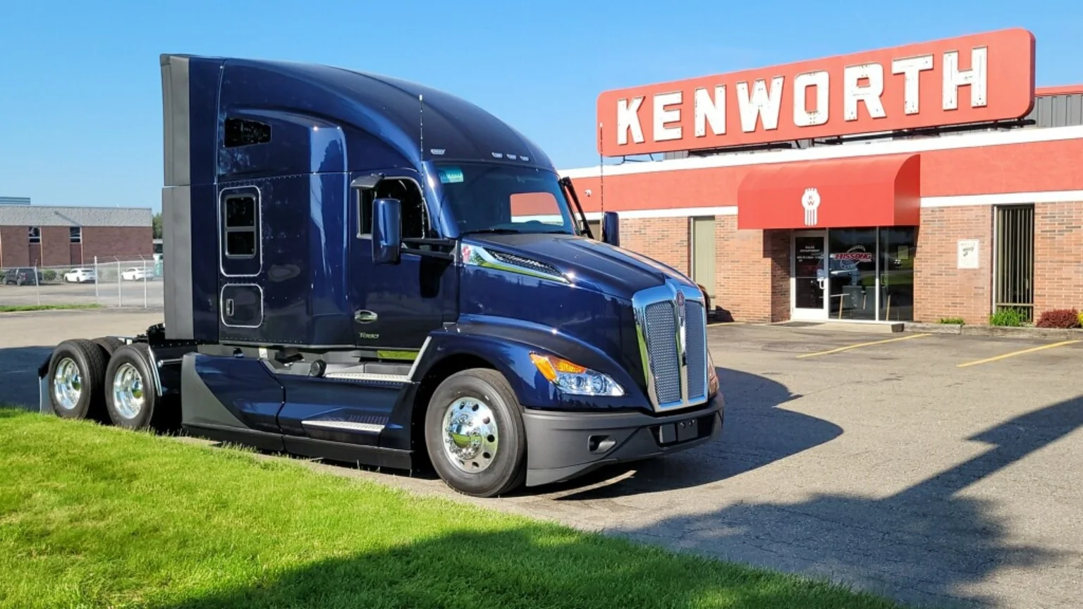 Blue semi truck parked outside